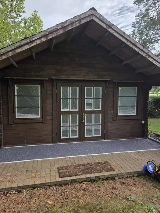 Cabin with windows and decking protected