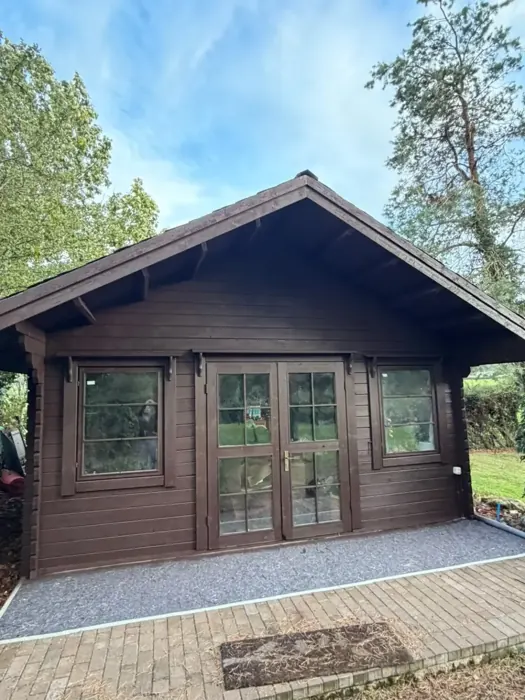 Front of the timber cabin after spray application