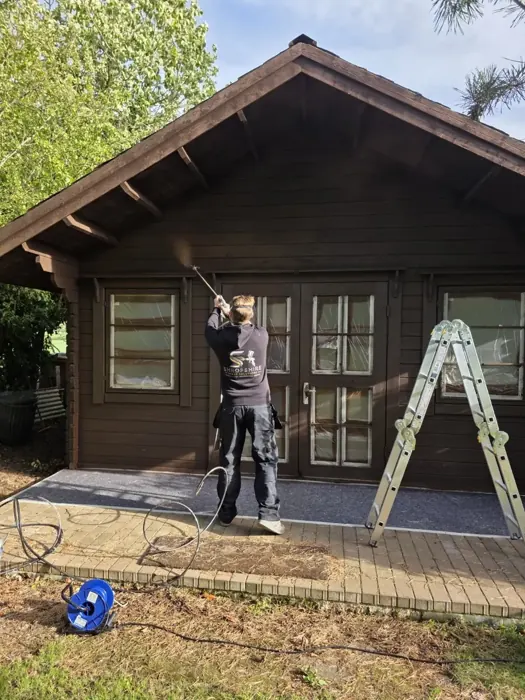 Spray application to the front of the timber cabin