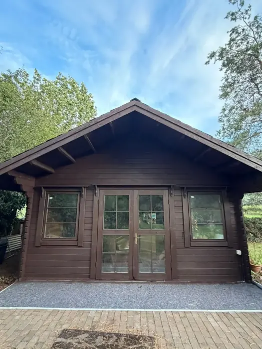Timber cabin and doors after spray application